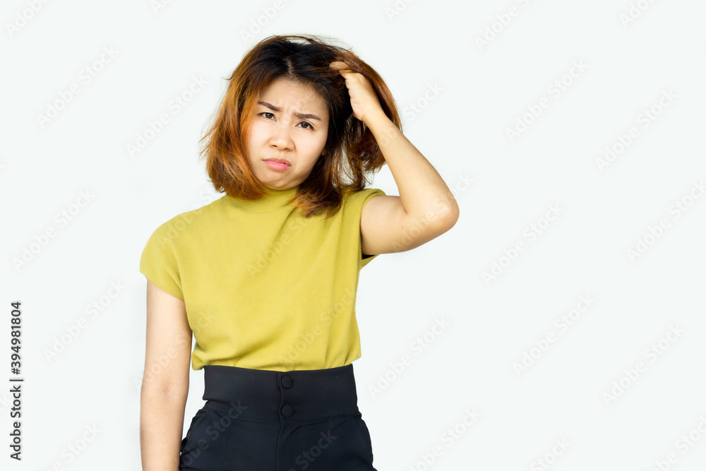stressed Asian woman scratching her itchy head having problem with dry skin and damaged hair caused by color dyes stressed Asian woman scratching her itchy head having problem with dry skin and damaged hair caused by color dyes