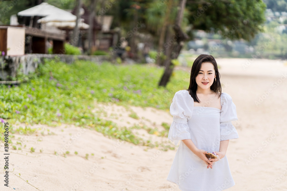 Beautiful woman walking on the beach in Phuket Thailand. Beautiful woman walking on the beach in Phuket Thailand.