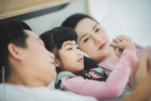Portrait of happy family spent time on bed in the morning