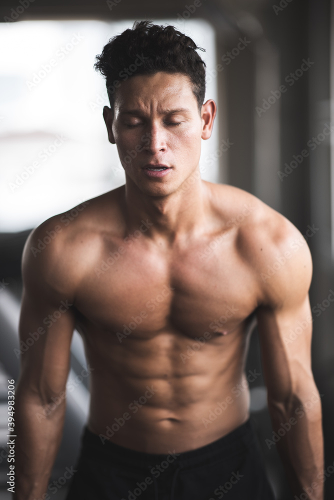 close up of muscle strength of male handsome sportman at the cadio fitness excercise and workout at gym club close up of muscle strength of male handsome sportman at the cadio fitness excercise and workout at gym club
