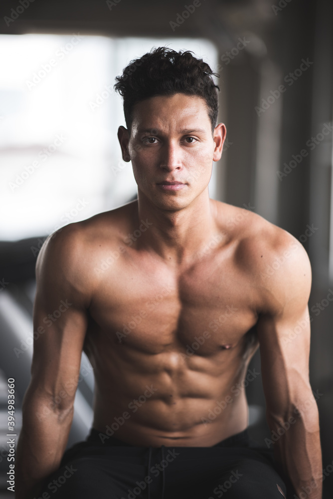 Fototapeta premium Muscular and strong athletic man exercising in sport gym.