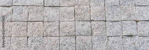 Texture of gray stone paving stones in close-up