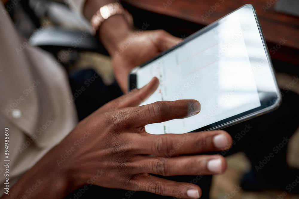 Nurture the future. Close up shot of hands holding tablet pc. Trader is using touch screen tablet for analyzing stock market chart, while working in the office Nurture the future. Close up shot of hands holding tablet pc. Trader is using touch screen tablet for analyzing stock market chart, while working in the office