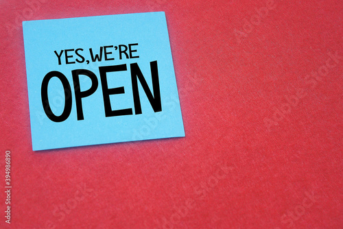 note paper written yes...we're open over red background