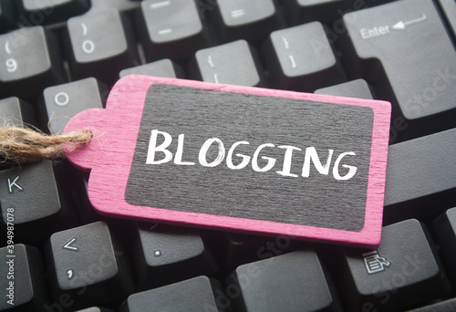 wooden tag written blogging over keyboard button background