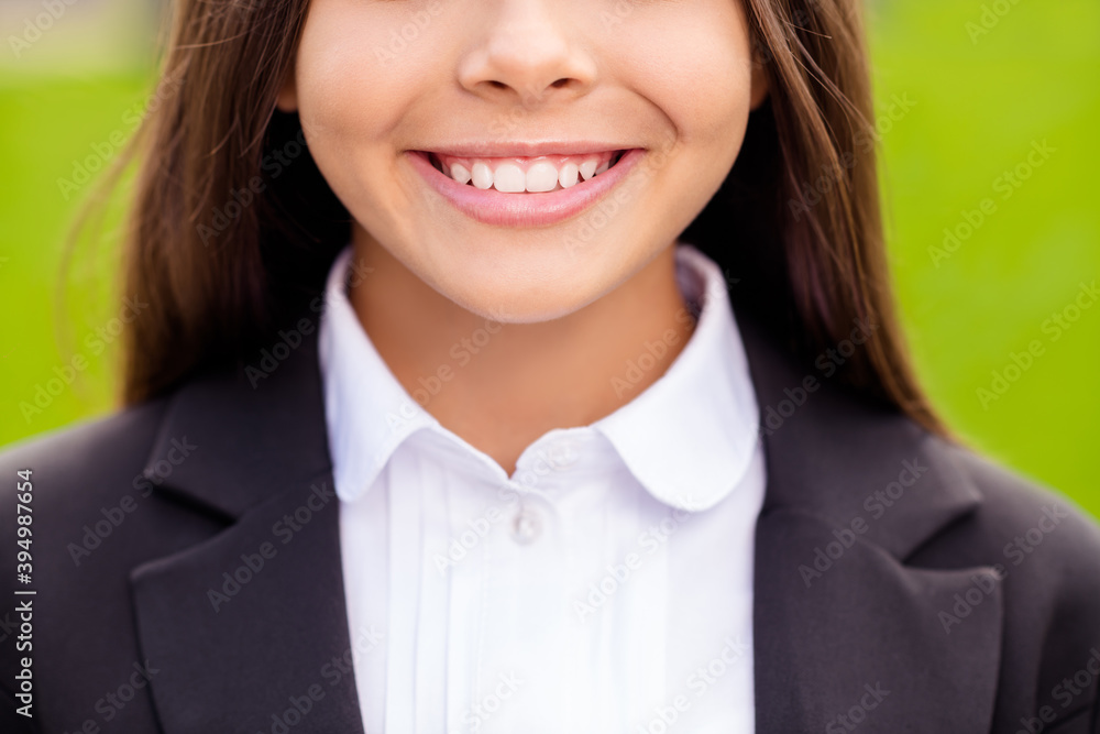 Cropped photo of small girl showing white teeth wear white shirt black jacket uniform city nature outdoors Cropped photo of small girl showing white teeth wear white shirt black jacket uniform city nature outdoors