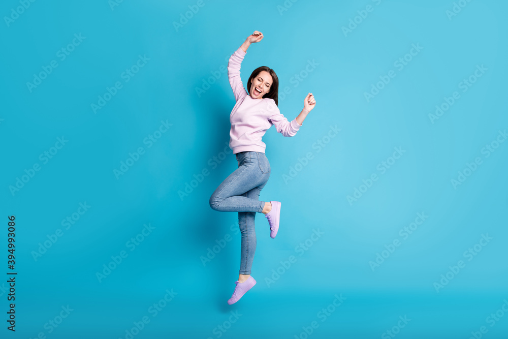 Fototapeta premium Full length photo of delighted girl celebrate spring season discount lottery win raise fists scream wear lilac pullover sneakers isolated over blue color background