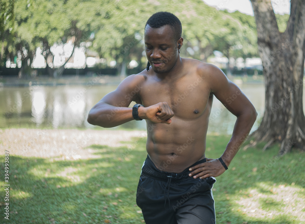 muscular young man exercise in green forest park muscular young man exercise in green forest park