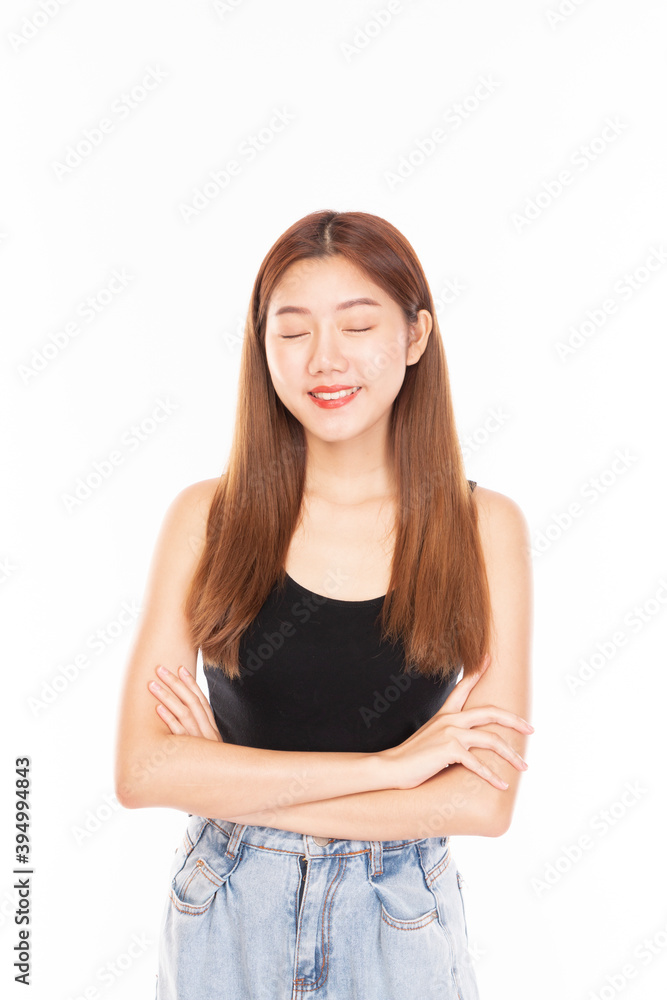 Fototapeta premium Portrait of young beautiful women with happy smile on white background with eyes closed. Attractive Cheerful young Asian girl smiling on white background. Young Asian pretty business woman.
