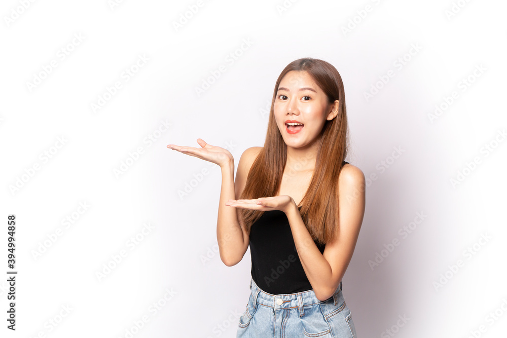 Young beautiful Asian girl presenting something on her hand.. Portrait of young beautiful women with happy smile on white background. Young Asian pretty business woman close up portrait. Young beautiful Asian girl presenting something on her hand.. Portrait of young beautiful women with happy smile on white background. Young Asian pretty business woman close up portrait.