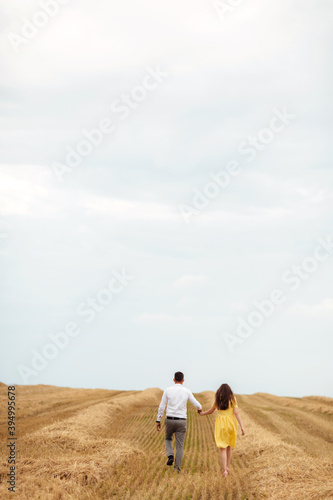 Happy young couple on straw, romantic people concept, beautiful landscape, summer season.