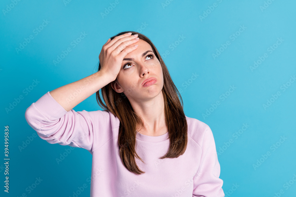 Photo of sad depressed lady look up empty space feel bad sick caught cold flu corona virus infection hold forehead wear casual purple sweatshirt pullover isolated blue color background
