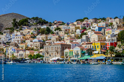 The charming and picturesque harbour if Simi is overlooked by rows of traditional houses each of them decorated with a Neoclassical façade and painted in bright pastel tones.  © Garry Basnett