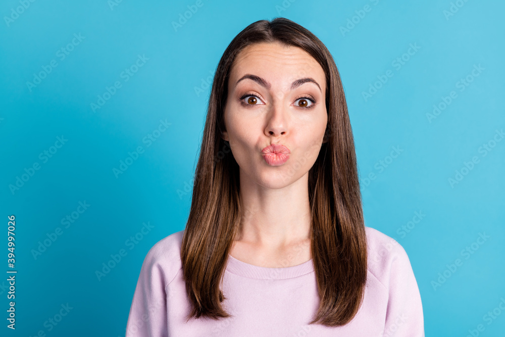 Fototapeta premium Closeup photo funny pretty flirty lady straight hairdo sending air kisses boyfriend good mood playful coquette tease wear casual pink sweatshirt pullover isolated blue color background