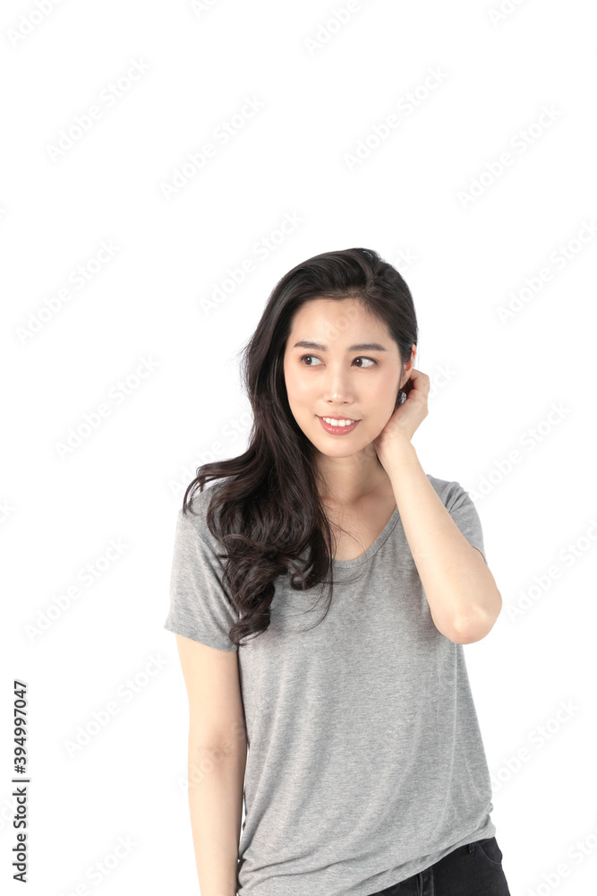 Happy cheerful young woman wearing gray t-shirt looking at camera with joyful and charming smile. Portrait of a pretty smiling woman posing isolated on a white background. Happy cheerful young woman wearing gray t-shirt looking at camera with joyful and charming smile. Portrait of a pretty smiling woman posing isolated on a white background.