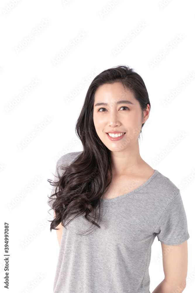 Happy cheerful young woman wearing gray t-shirt looking at camera with joyful and charming smile. Portrait of a pretty smiling woman posing isolated on a white background. Happy cheerful young woman wearing gray t-shirt looking at camera with joyful and charming smile. Portrait of a pretty smiling woman posing isolated on a white background.