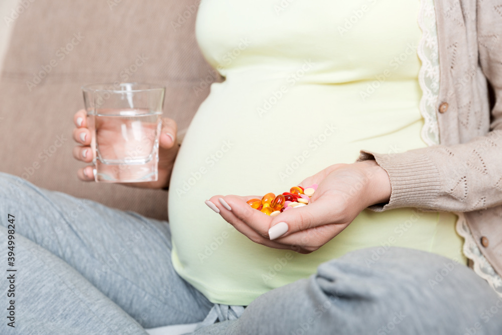 woman holding pill and glass of fresh pure water. Healthy millennial women taking antioxidant medicine vitamins, healthcare concept woman holding pill and glass of fresh pure water. Healthy millennial women taking antioxidant medicine vitamins, healthcare concept