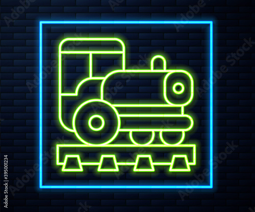 Glowing neon line Vintage locomotive icon isolated on brick wall background. Steam locomotive. Vector.