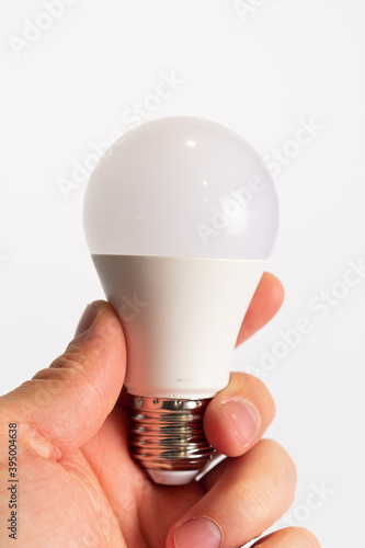 Eco lamp in hand. Led lamp, green technologies. Eco lamp. Energy efficiency concept.