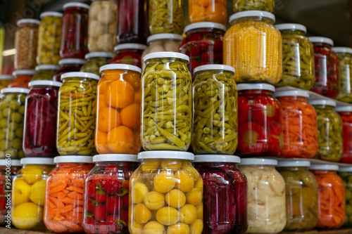 Various preserved pickled vegetables in glass jars. Marinated food and organic raw vegetables, canned homemade food concept. Preservation and storage of vegetarian food for the winter 