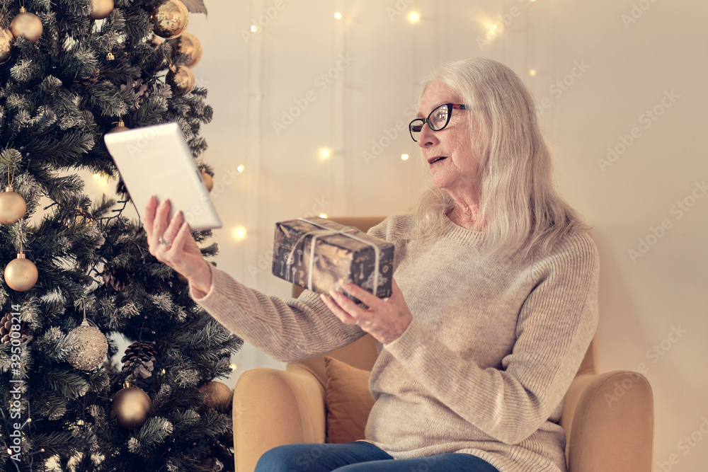 Senior woman talking with family during online call . Happy grandmothers during video conference celebrating winter holidays. soft focus, warm tones Senior woman talking with family during online call . Happy grandmothers during video conference celebrating winter holidays. soft focus, warm tones