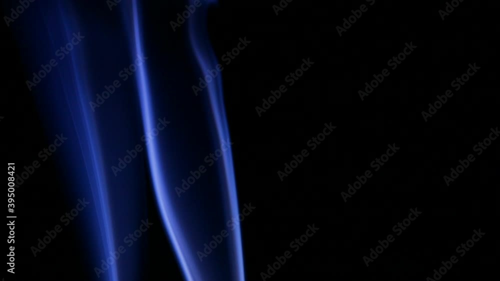 blue smoke slow motion on a black background, abstraction with smoke