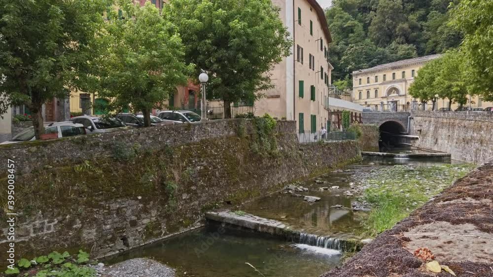 picturesque creek and little waterfall in the old Italian town of Porretta in Italy picturesque creek and little waterfall in the old Italian town of Porretta in Italy