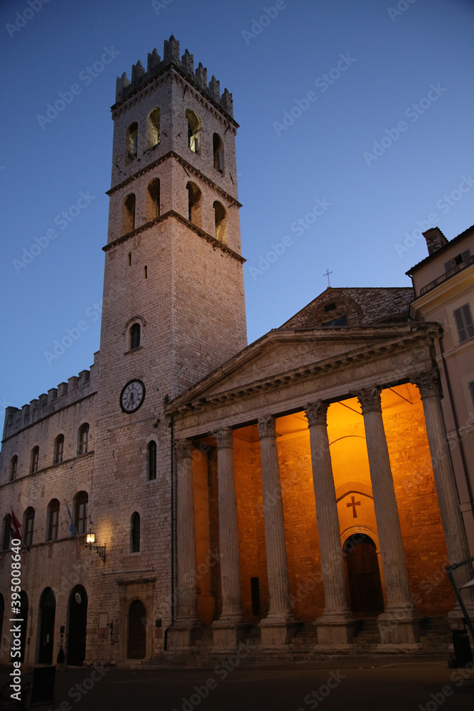 Square of the town of Assisi with the tower bell, in the evening