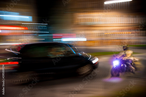 Dangerous city traffic situation with a motorcyclist and a car in motion blur © vbaleha