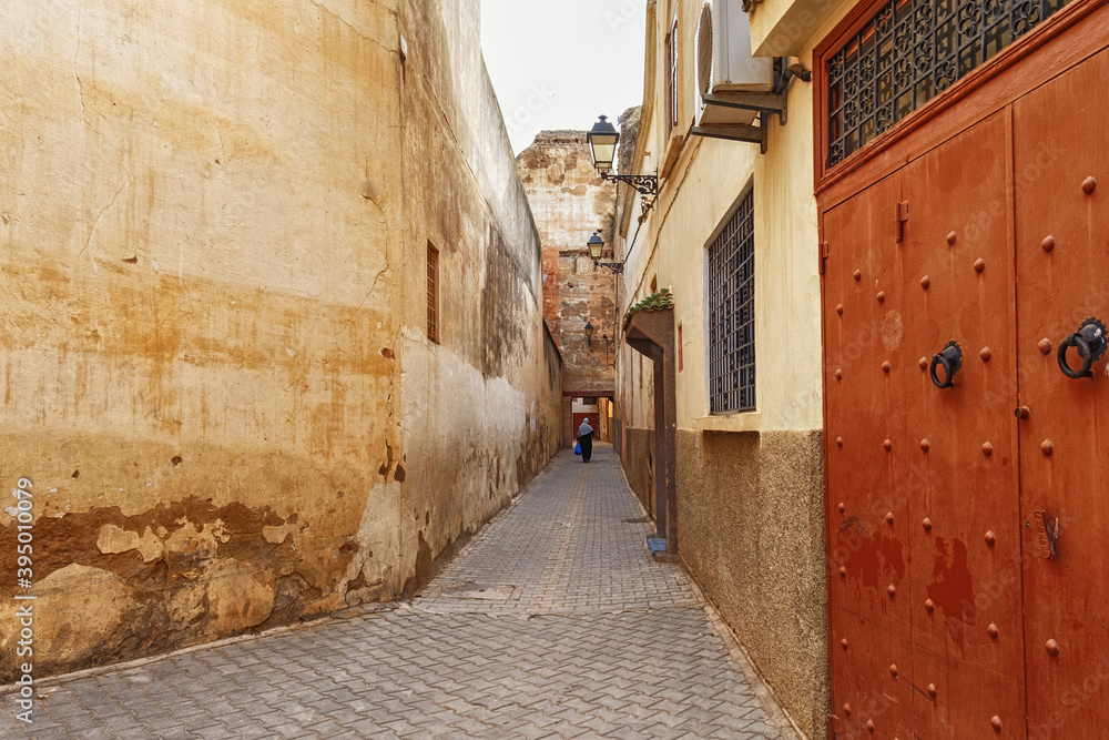 Unknown women on the narrow street in Meknes medina. Meknes is one of the four Imperial cities of Morocco and the sixth largest city by population in the kingdom.
