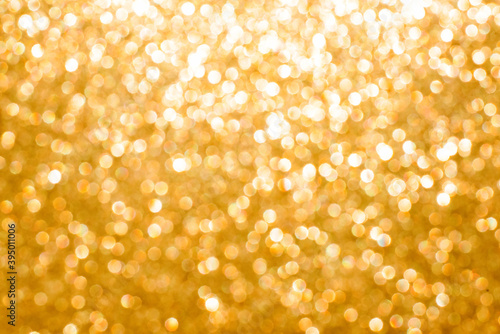 Abstract background of golden bokeh with glow effect, festive christmas background.