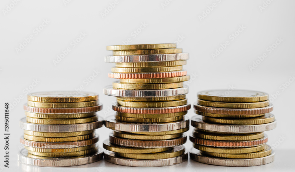 row of coin stack growing pile on white background for money saving and investment business financial and banking concept. row of coin stack growing pile on white background for money saving and investment business financial and banking concept.