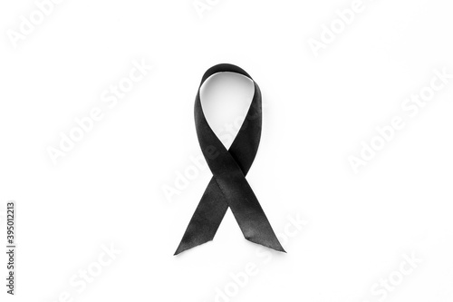 Black awareness ribbon isolated on a white background. Top view