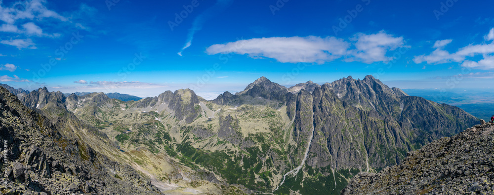 Mountain stone range peak against blue cloudy sky. Nature landscape. Travel background. National Park High Tatra, Slovakia, Europe.