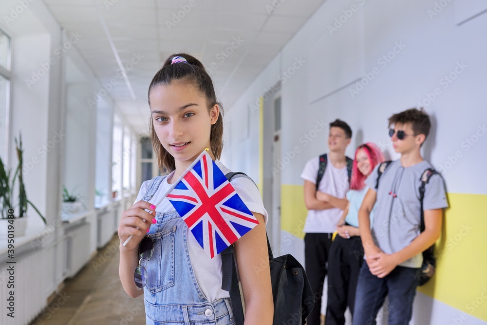 Teenager student with British flag, school corridor group of students background Teenager student with British flag, school corridor group of students background