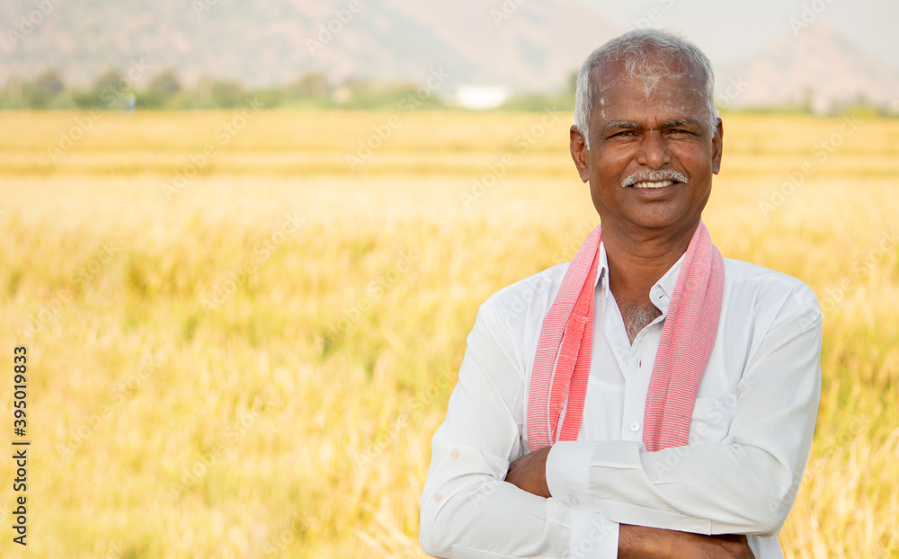 Portrait of Confident smiling Indian farmer with arms crossed standing ...