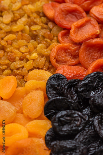 Raisins, prunes, dried fruits as a background.