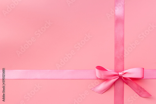 Festive pink ribbon with bow for holiday gift box or greeting card. Top view © 9dreamstudio