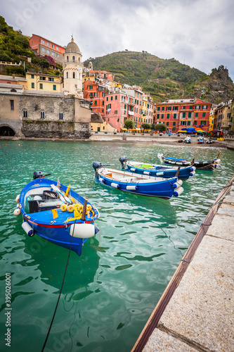 Boats and houses in the small harbour of Vernazza in Cinque Terre,  Italy #395026001