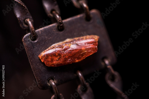 Part of a metal and amber necklace