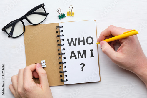 Handwritten question who am i concept on paper photo