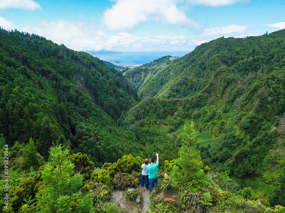 Young Couple over looking to landscape in Lombadas Valley in the São Miguel Island. Azores, Portugal.