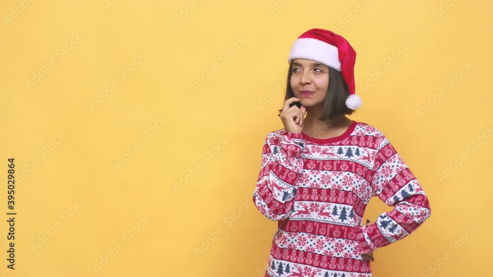Young latin woman celebrating christmas day looking sideways with doubtful and skeptical expression Young latin woman celebrating christmas day looking sideways with doubtful and skeptical expression