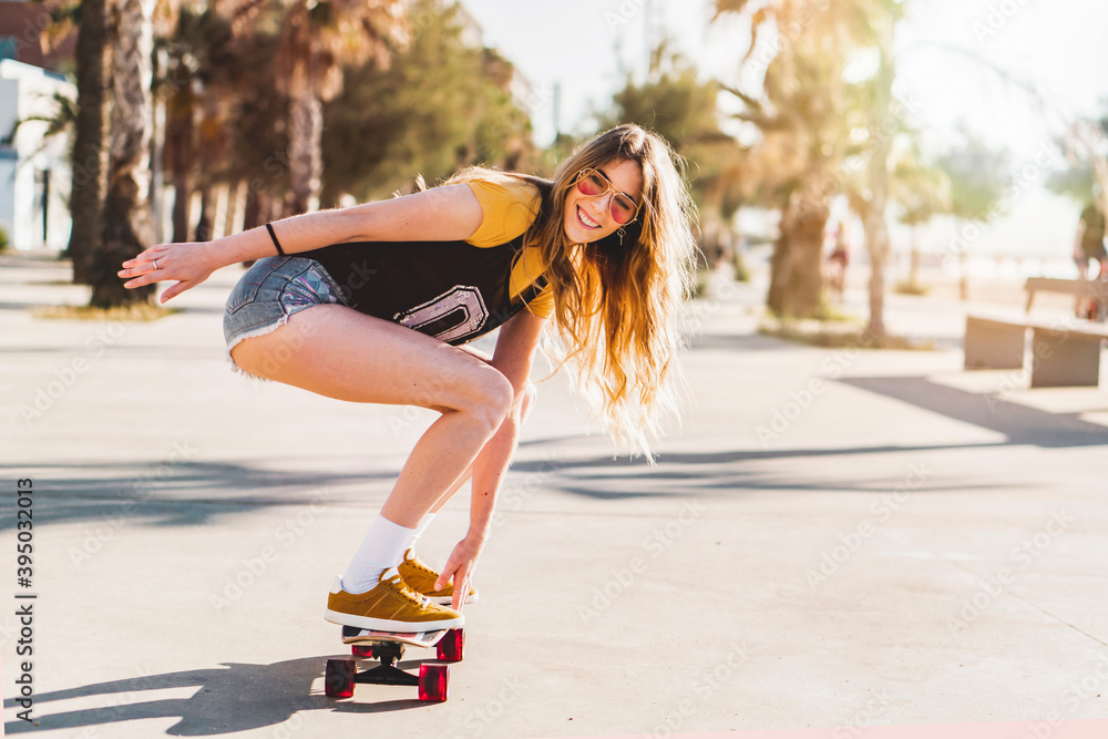 Premium Photo  Vertical fulllength photo of a stylish skater woman in casual  baggy clothes holding a longboard