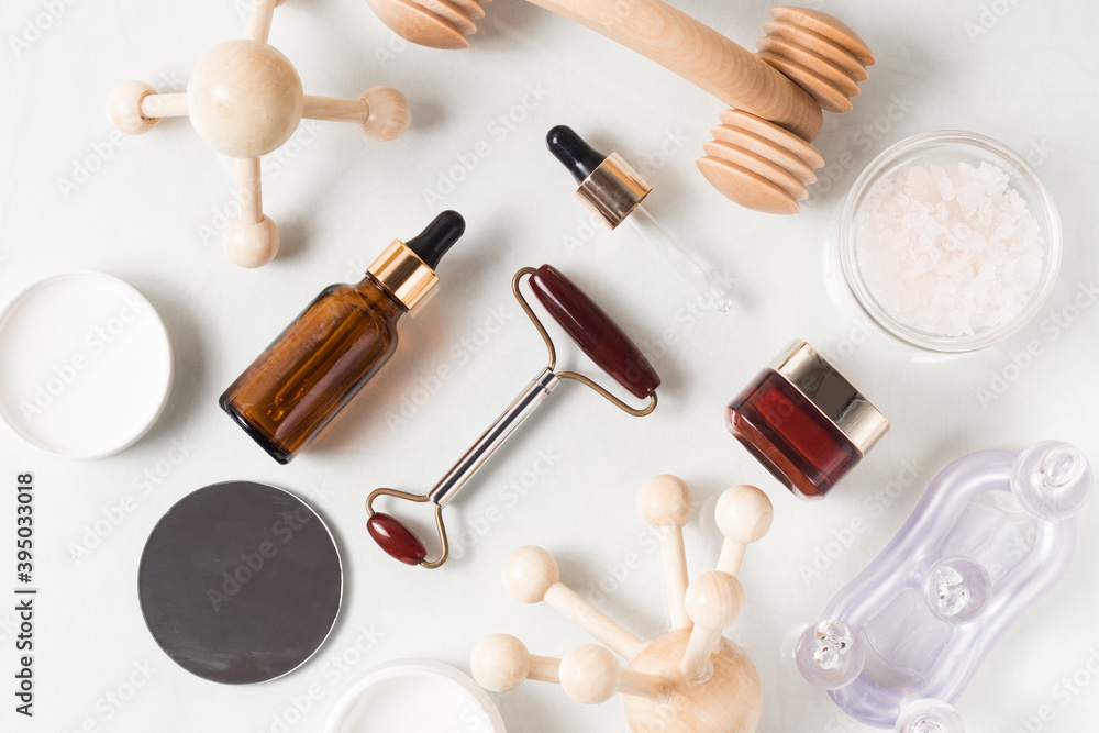 Zero waste organic spa cosmetics set on white background. top view of amber glass bottles and massage devices. Beauty products packing design. Image for spa salons Zero waste organic spa cosmetics set on white background. top view of amber glass bottles and massage devices. Beauty products packing design. Image for spa salons