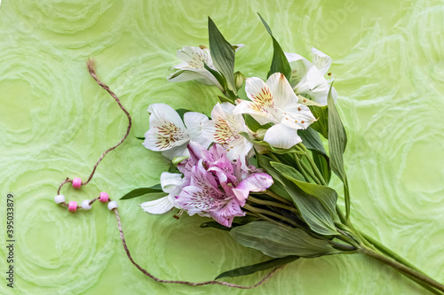 Bouquet of pink and white astromeria flowers on a green background. Spring photo