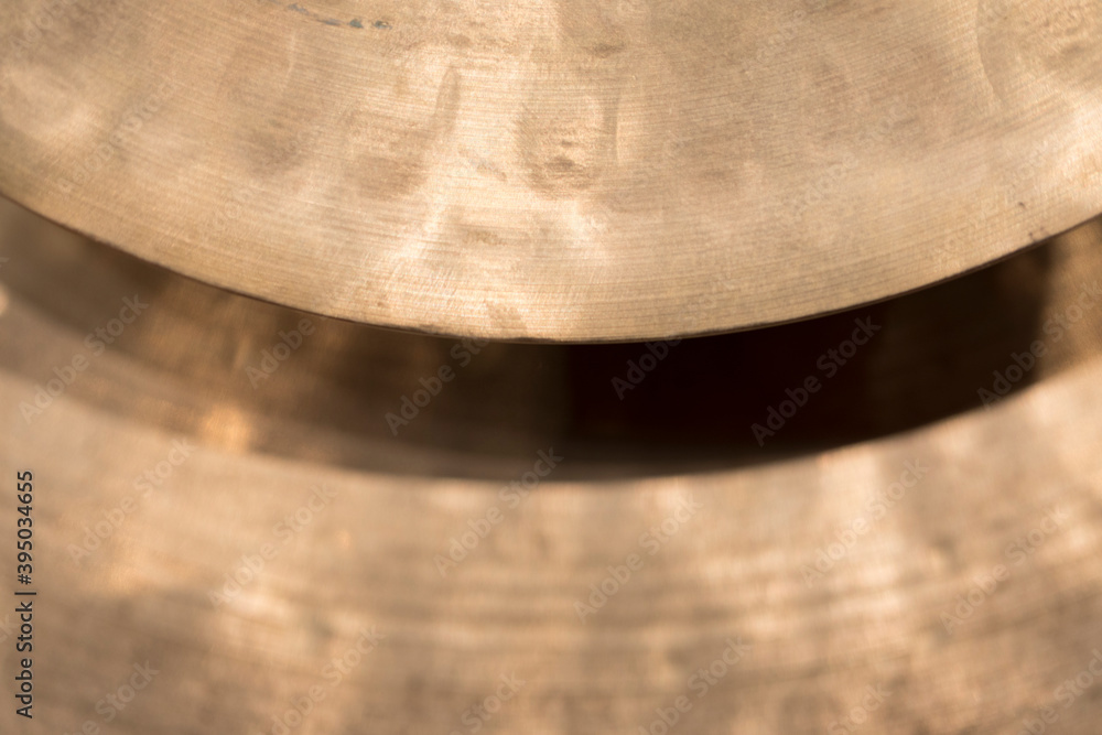 A part of two metal percussion cymbals A part of two metal percussion cymbals