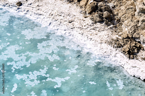 Texture of Dead Sea. Salty sea shore background. Salt accumulation on the Dead Sea shore in Jordan