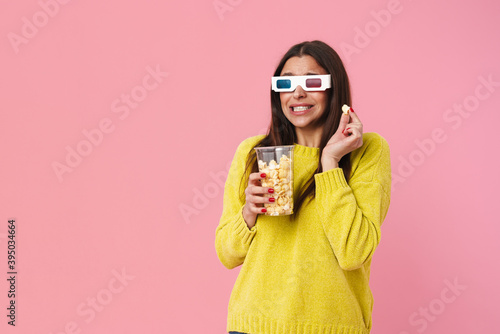 Shocked nice girl in 3d glasses watching movie and eating popcorn