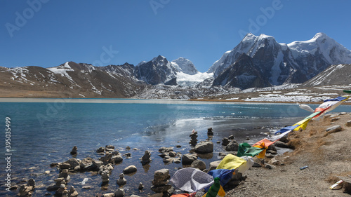 Prayer flags at Gurudongmar Lake with zemu glacier in the background at Sikkim India
 photo